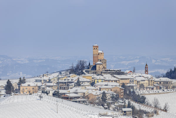 Langhe, Cuneo district, Piedmont, Italy. Langhe wine region winter snow, Serralunga d’Alba castle
