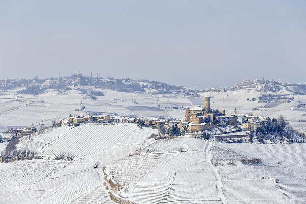 Langhe, Cuneo district, Piedmont, Italy. Langhe wine region winter snow, Castiglione Falletto castle