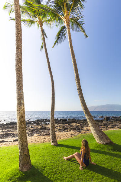 A girl enjoing the sunset in Kihei beach, Maui island, Hawaii, USA