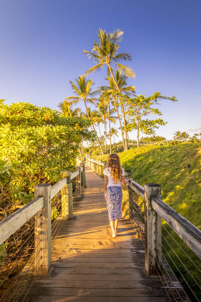 A girl enjoing the sunset in Kihei beach, Maui island, Hawaii, USA