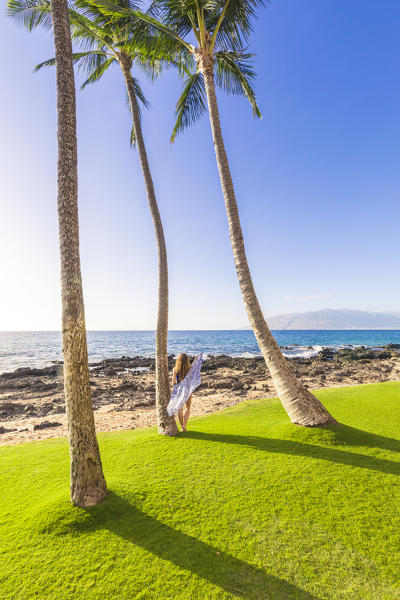 A girl enjoing the sun in Maui, near Makena beach, Maui island, Hawaii, USA