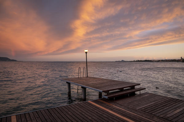 Western side of Garda lake during a cloudy sunset. Toscolano Maderno, Brescia Province, Lombardy, Italy