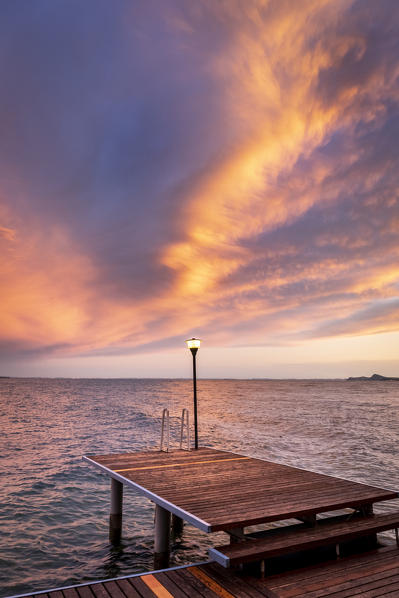 Western side of Garda lake during a cloudy sunset. Toscolano Maderno, Brescia Province, Lombardy, Italy