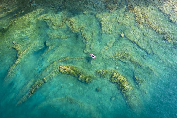 High view of a small boat on Garda LAke near Salò, Brescia province, Lombardy, Italy