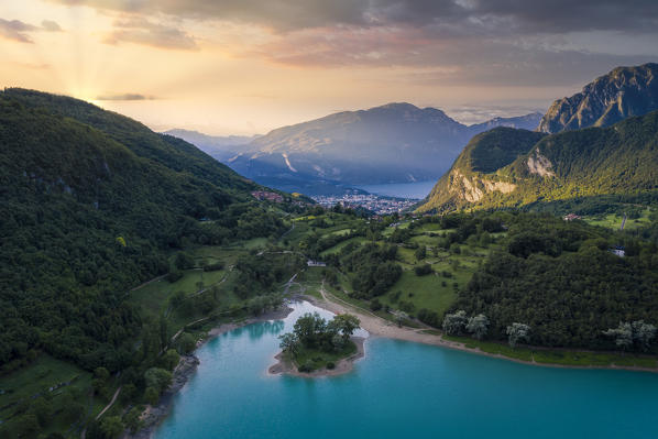 Tenno lake on the foreground and Garda Lake on the back ground during sunrise. Trentino Alto Adige, Italy.