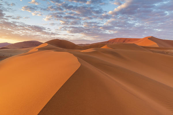 Sun rising over the red sand dunes of the Namib Desert, Namibia. Stock  Photo