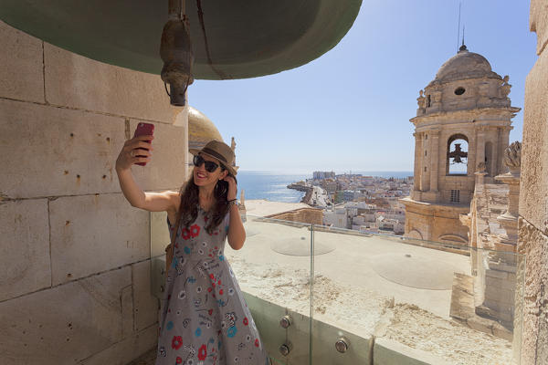 A tourist takes a selfie on the bell tower of the Cathedral, Cádiz, province of Cádiz, Andalusia, Spain
