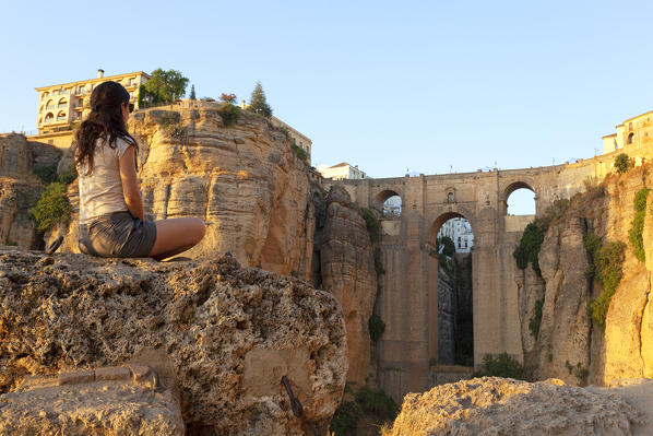 A tourist admires the Puente Nuevo bridge at sunset, Ronda, province of Málaga, Andalusia, Spain
