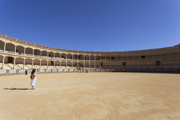 A tourist in the Ronda bullring, Plaza de Toros, Ronda, province of Málaga, Andalusia, Spain