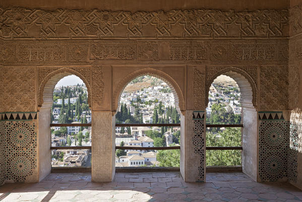 The arabic aeches of Alhambra, with the houses of Albaicín neighborhood in the background, Granada, province of Granada, Andalusia, Spain