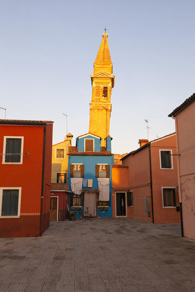 The typical colored houses and the leaning bell tower of Burano Island, Venice, Veneto, Italy.