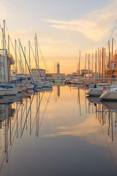 Sunset on the port of Trieste, with the old lighthouse. Trieste, Friuli-Venezia Giulia, Italy