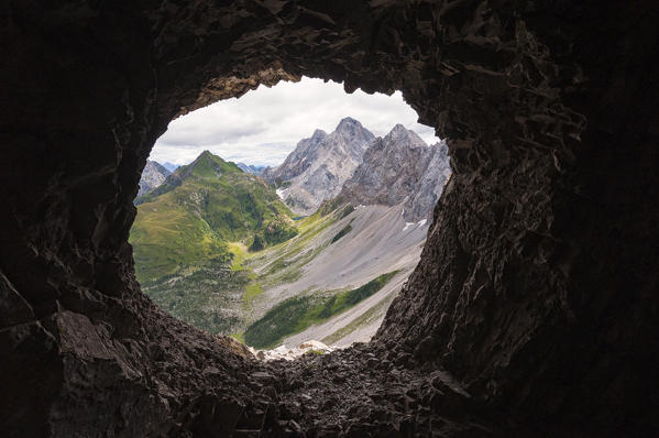 Rauchkofel, Coglians and Lastrons del Lago mountains with Volaia Lake, seen from a war cave on the ridge of Volaia Mount. Carnic Alps, Volaia Mounts group, Forni Avoltri, Udine province, Friuli Venezia Giulia, Italy.