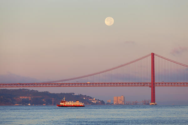 Moonset on Ponte 25 de Abril (April 25 Bridge) at dawn, Lisbon, Lisbon Metropolitan Area, Portugal 