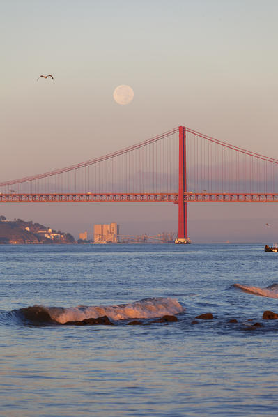 Moonset on Ponte 25 de Abril (April 25 Bridge) at dawn, Lisbon, Lisbon Metropolitan Area, Portugal 