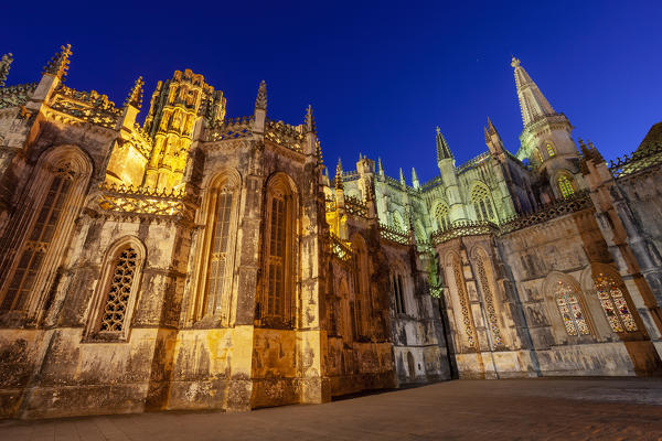 The Gothic forms of Batalha Monastery illuminated in the evening, Batalha municipality, Leiria district, Estremadura province, Portugal.
