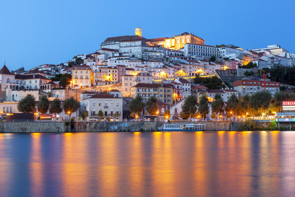View of Coimbra ol town and Mondego River at dusk. Coimbra, Coimbra district, Centro Region, Portugal.