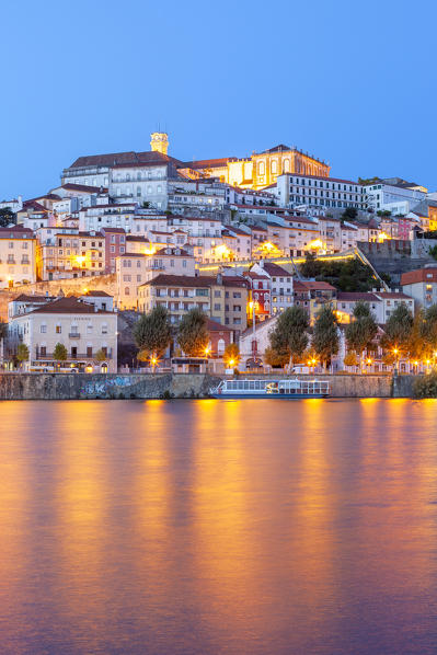 View of Coimbra ol town and Mondego River at dusk. Coimbra, Coimbra district, Centro Region, Portugal.