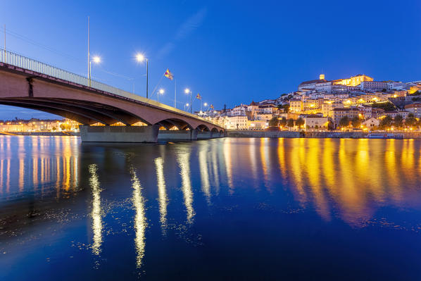 View of Coimbra old town and Santa Clara Bridge at dusk.  Coimbra, Coimbra district, Centro Region, Portugal.