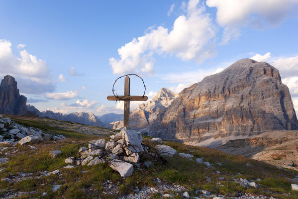 The summit cross on Cima di Falarego, built by remains of WWI, with Tofane Group on the background, Dolomites, Cortina d'Ampezzo, Belluno province, Veneto, Italy.