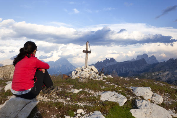 A hiker observes the panorama from Cima di Falzarego, Dolomites, Cortina d'Ampezzo, Belluno province, Veneto, Italy.