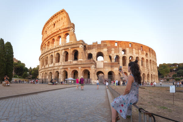 A tourist takes a shot of Colosseum at sunset, Rome, Lazio, Italy.  (MR)