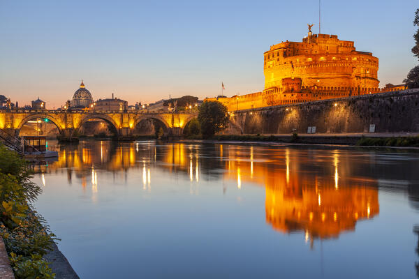 Castel Sant'Angelo and Ponte Sant'Angelo at dusk reflected on Tiber river, Rome, Lazio, Italy.