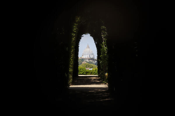 The dome of St. Peter's Basilica from the keyhole of Order of Matla, Aventine Hill, Rome, Lazio, Italy.