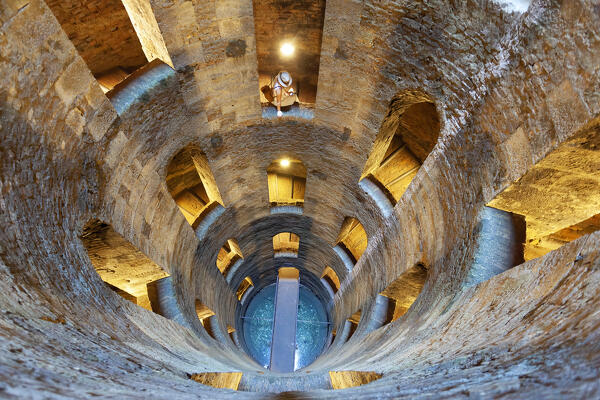 A tourist in St. Patrick's Well (Pozzo di San Patrizio), a historic well in Orvieto, Terni province, Umbria region, Italy. (MR)
