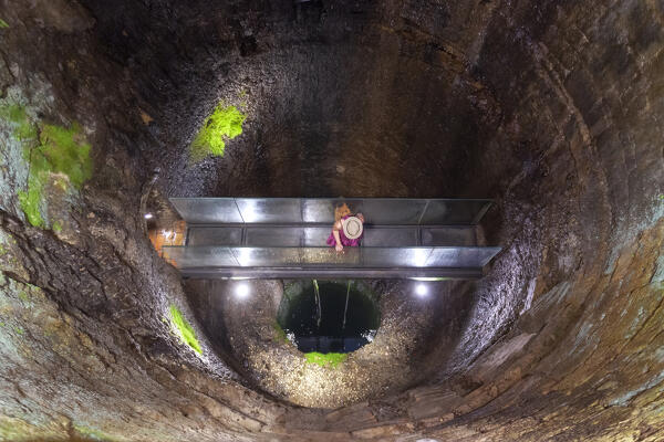 A tourist in the Etruscan Well, Perugia, Umbria region, Italy. (MR)