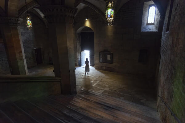 A tourist at the entrace to Palazzo dei Priori in Città di Castello, Perugia province, Umbria region, Italy.