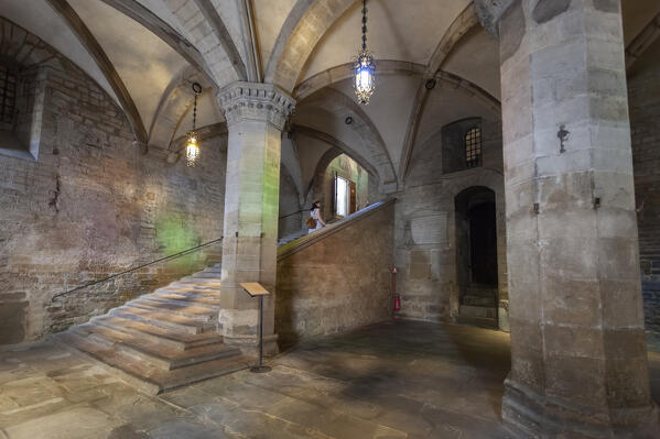 A tourist at the entrace to Palazzo dei Priori in Città di Castello, Perugia province, Umbria region, Italy.