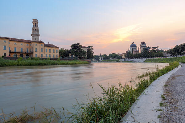 River Adige at sunset with the bell tower of Verona Cathedral on the left and San Giorgio in Braida on the right. Verona, Veneto, Italy.
