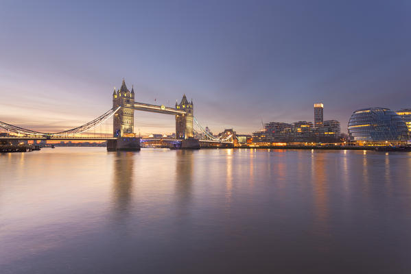 Tower Bridge area at dawn reflected in river Thames, London, Great Britain, UK