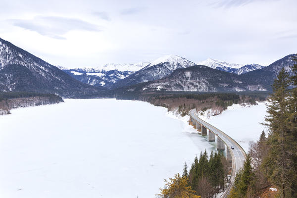 Sylvenstein bridge on frozen lake Sylvensteinsee, Lenggries, Bad Tölz-Wolfratshausen district, Upper Bavaria, Germany, Europe