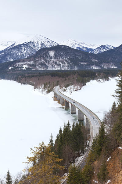 Sylvenstein bridge on frozen lake Sylvensteinsee, Lenggries, Bad Tölz-Wolfratshausen district, Upper Bavaria, Germany, Europe