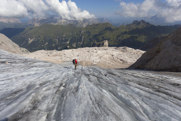 A mountianeer goes dawn the Marmolada glacier, Marmolada group, Dolomites, Canazei, Trento province, Trentino-Alto Adige, Italy