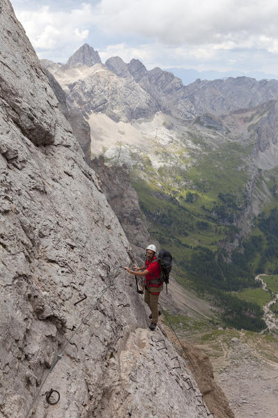 A hiker at Forcella Marmoalda, Marmolada group, Dolomites, Canazei, Trento province, Trentino-Alto Adige, Italy