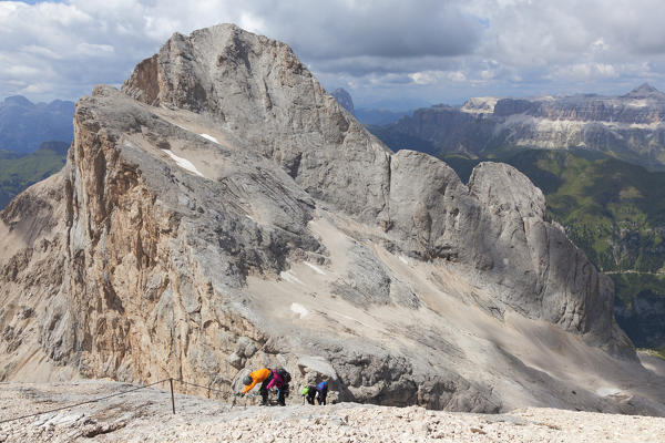 Mountaineers climb the Via Ferrata of West Ridge, Marmolada group, Dolomites, Canazei, Trento province, Trentino-Alto Adige, Italy