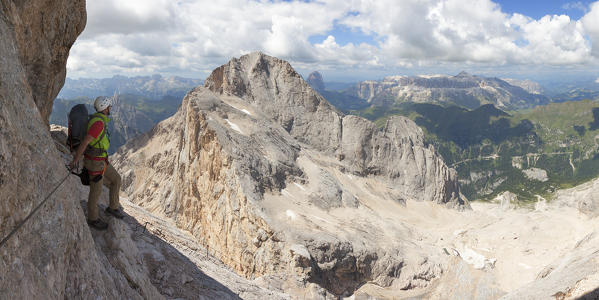 A mountaineer climbs the Via Ferrata of West Ridge, Marmolada group, Dolomites, Canazei, Trento province, Trentino-Alto Adige, Italy