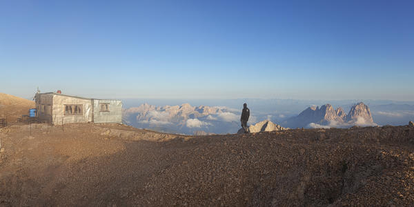Hiker at Punta Penia hut, Marmolada group, Dolomites, Canazei, Trento province, Trentino-Alto Adige, Italy