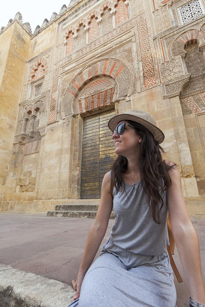 A tourist in front of Puerta de San José, Mosque–Cathedral of Córdoba, Córdoba municipality, province of Córdoba, Andalusia, Spain