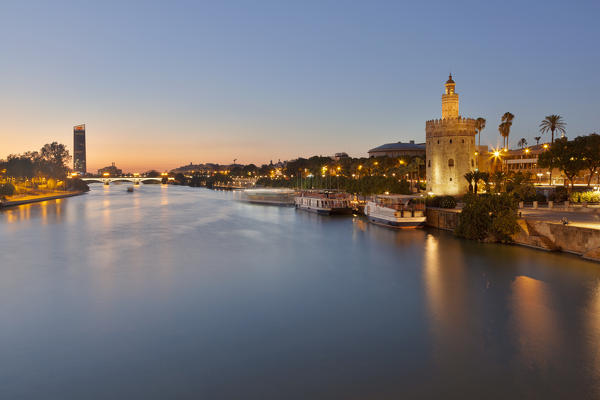 Torre del Oro (Tower of Gold) and river Guadalquivir at dusk from San Telmo bridge, Seville, province of Seville, Andalusia, Spain