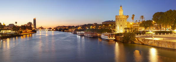 Torre del Oro (Tower of Gold) and river Guadalquivir at dusk from San Telmo bridge, Seville, province of Seville, Andalusia, Spain