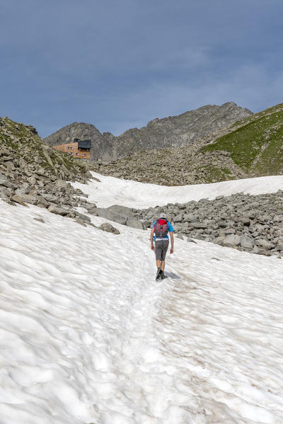 Selva dei Molini, province of Bolzano, South Tyrol, Italy, Europe. Hiker on the trail to the Edelraut refuge (MR)