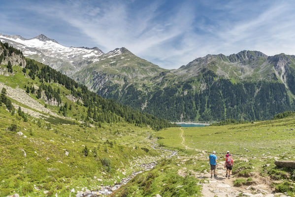 Selva dei Molini, province of Bolzano, South Tyrol, Italy, Europe. Hikers on the trail between lake Neves and Edelraut refuge (MR)