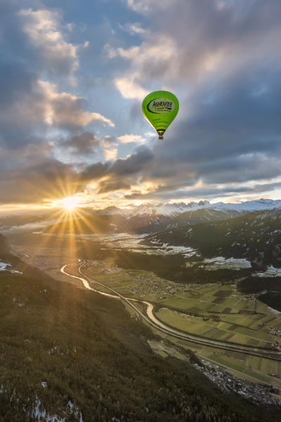 Seefeld, Tyrol, Austria, Europe. Crossing the alps in a hot air balloon. The hot air balloon above the Inn Valley at sunrise