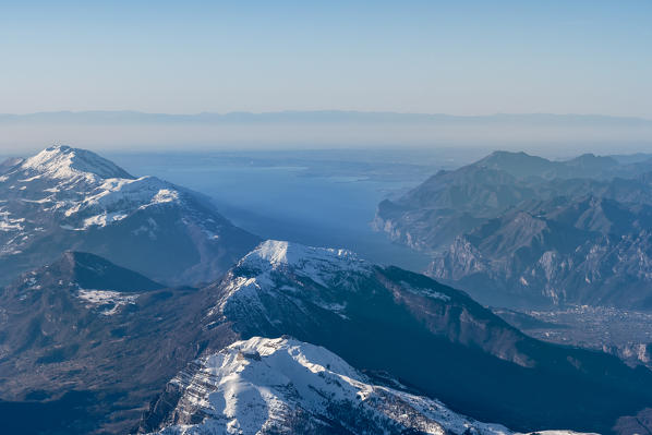 Trento, Trentino - South Tyrol, Italy, Europe. Crossing the alps in a hot air balloon. View from the Balloon to the Lake Garda, Mount Stico and Mount Baldo. In the background the Apennines mountains