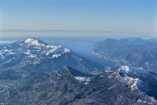Trento, Trentino - South Tyrol, Italy, Europe. Crossing the alps in a hot air balloon. View from the Balloon to the Lake Garda, Mount Stico and Mount Baldo. In the background the Apennines mountains