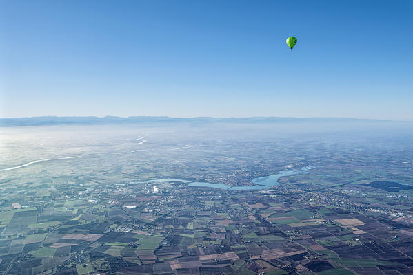 Mantova, Lombardy, Italy, Europe. Crossing the alps in a hot air balloon. View from the Balloon to the city of Mantova and the Mincio river. In the background the Po river
